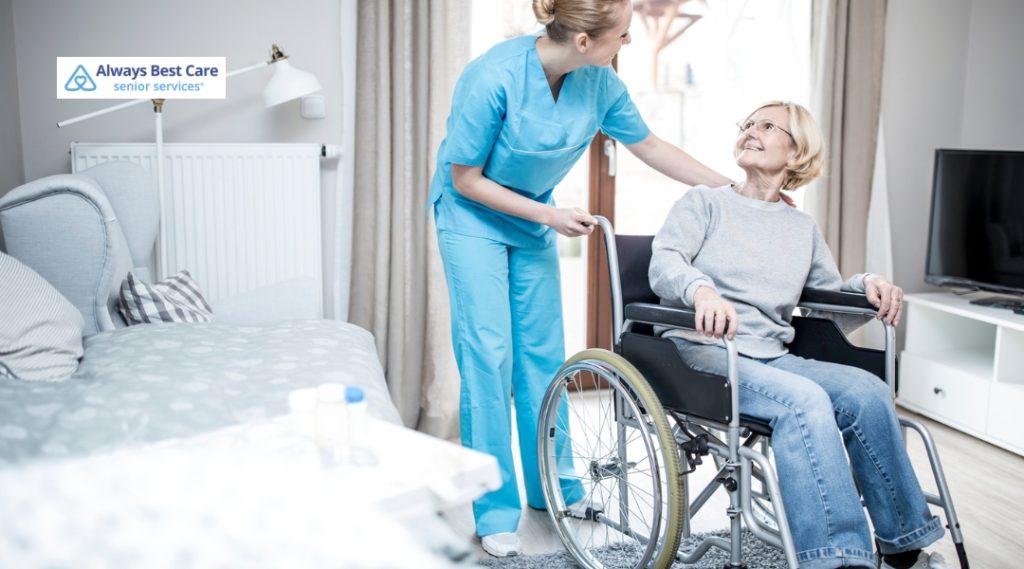 A caregiver is helping a senior in a wheelchair, offering both physical and emotional support in a cozy home environment.