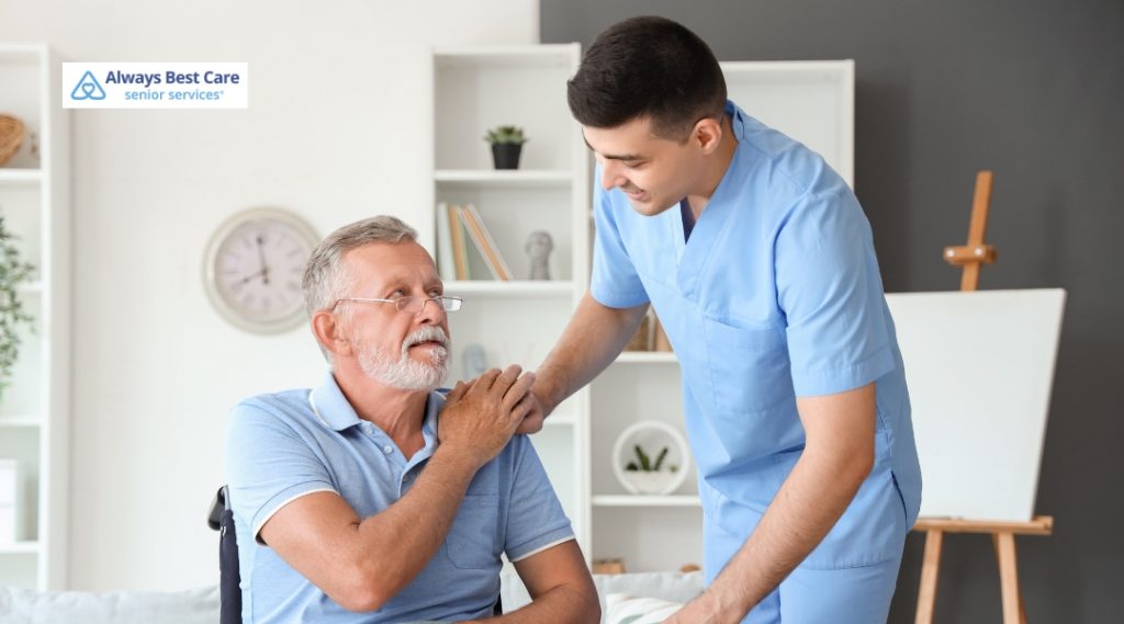 A healthcare professional assists a senior in a wheelchair, providing support with a comforting touch during an in-home care session.
