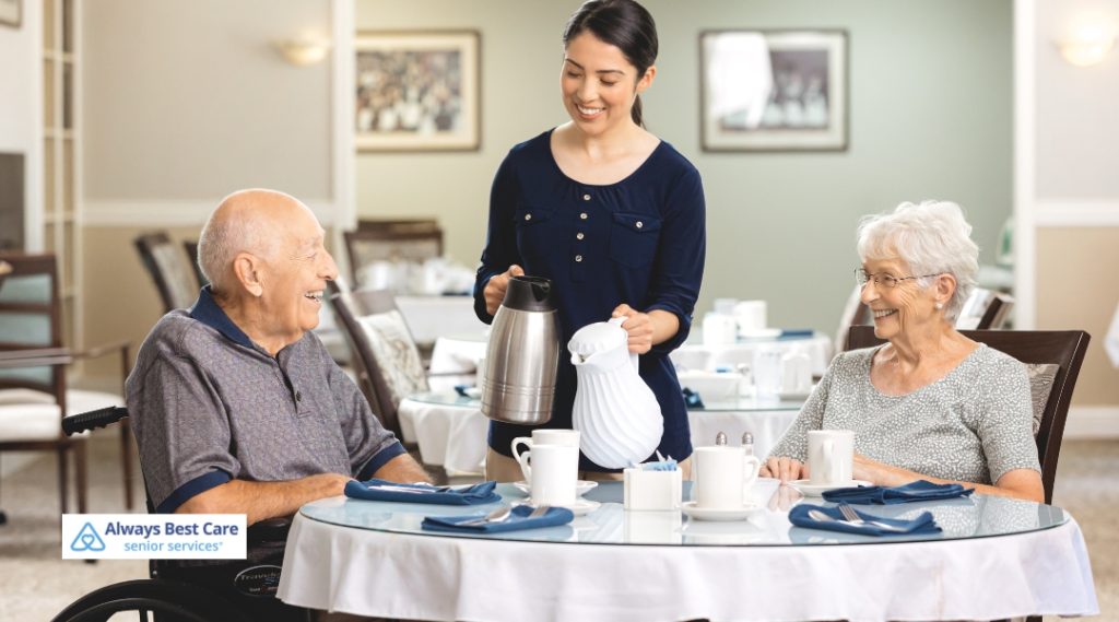 Seniors on a dining table with a caregiver