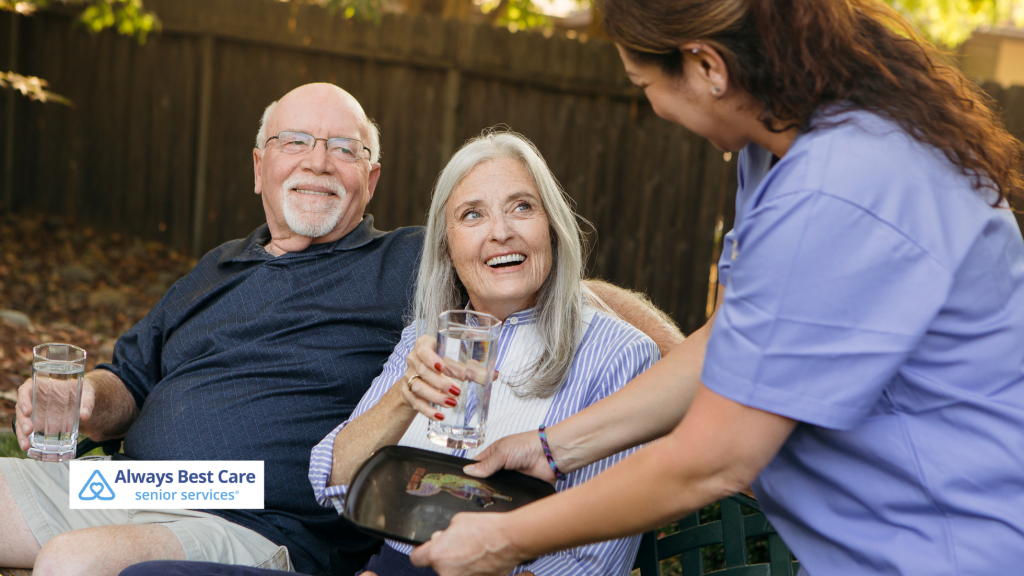 two seniors with a caregiver