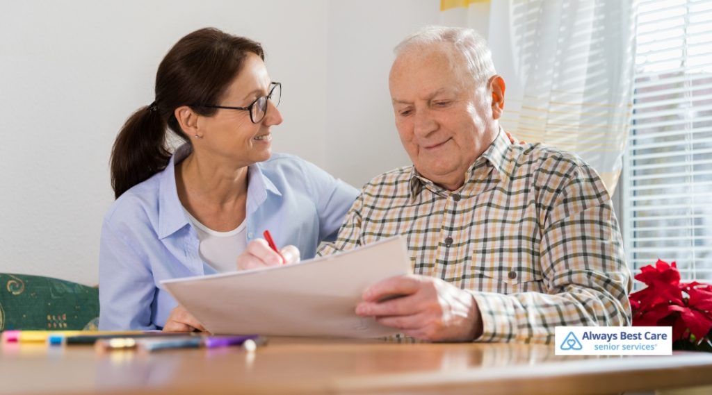 A caregiver guiding a senior through a crossword puzzle or large-print word search.