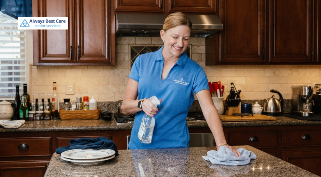 caregiver cleaning the kitchen top